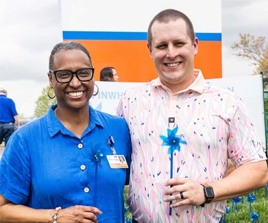 Woman and man holding pinwheels