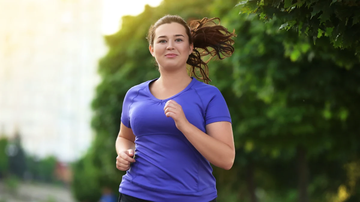 Young woman jogging outdoors – great for blog posts about motivation, exercise tips, or lifestyle changes