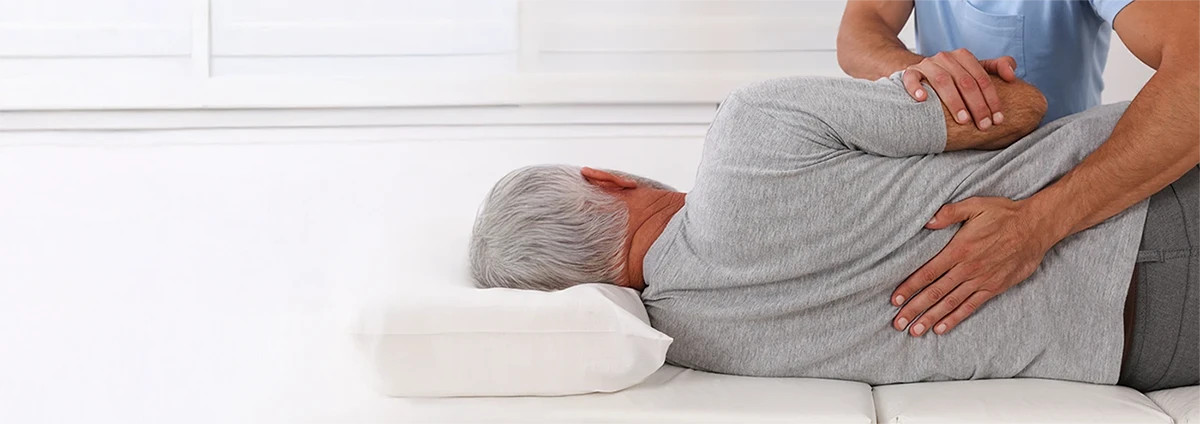 A man receives chiropractic care on his back