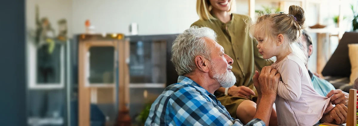 Smiling older man talks with young girl