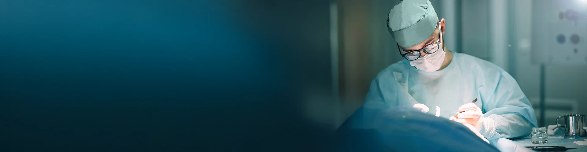 A surgeon performs surgery in an operating room.