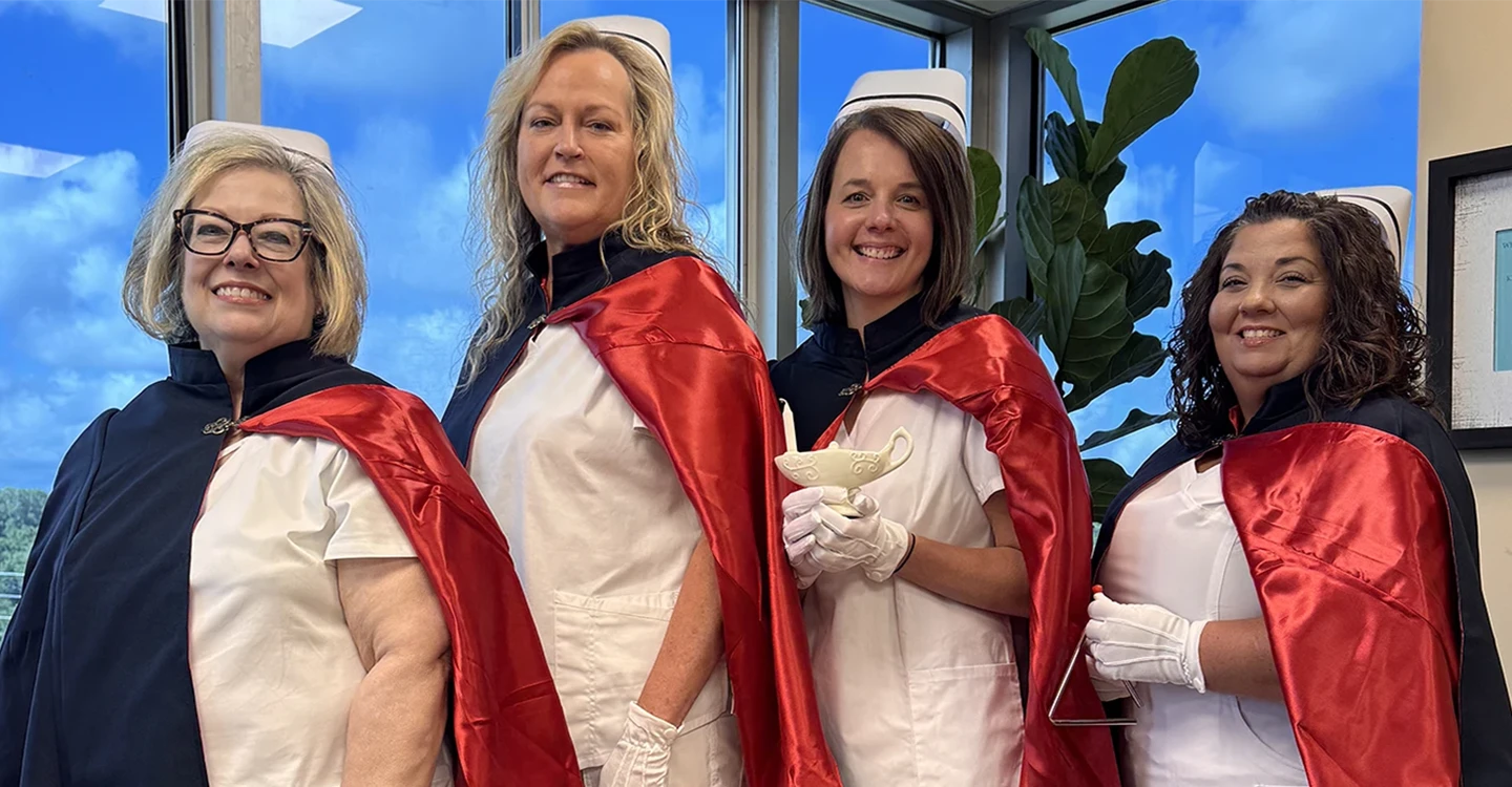 4 nurses in the local nurse honor guard wear their nurse caps and capes