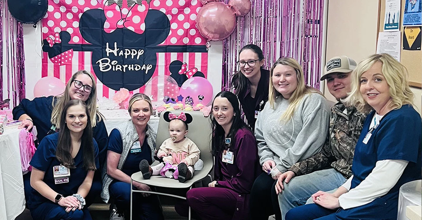 girl toddler at her birthday party with her parents and Atrium Health Floyd staff