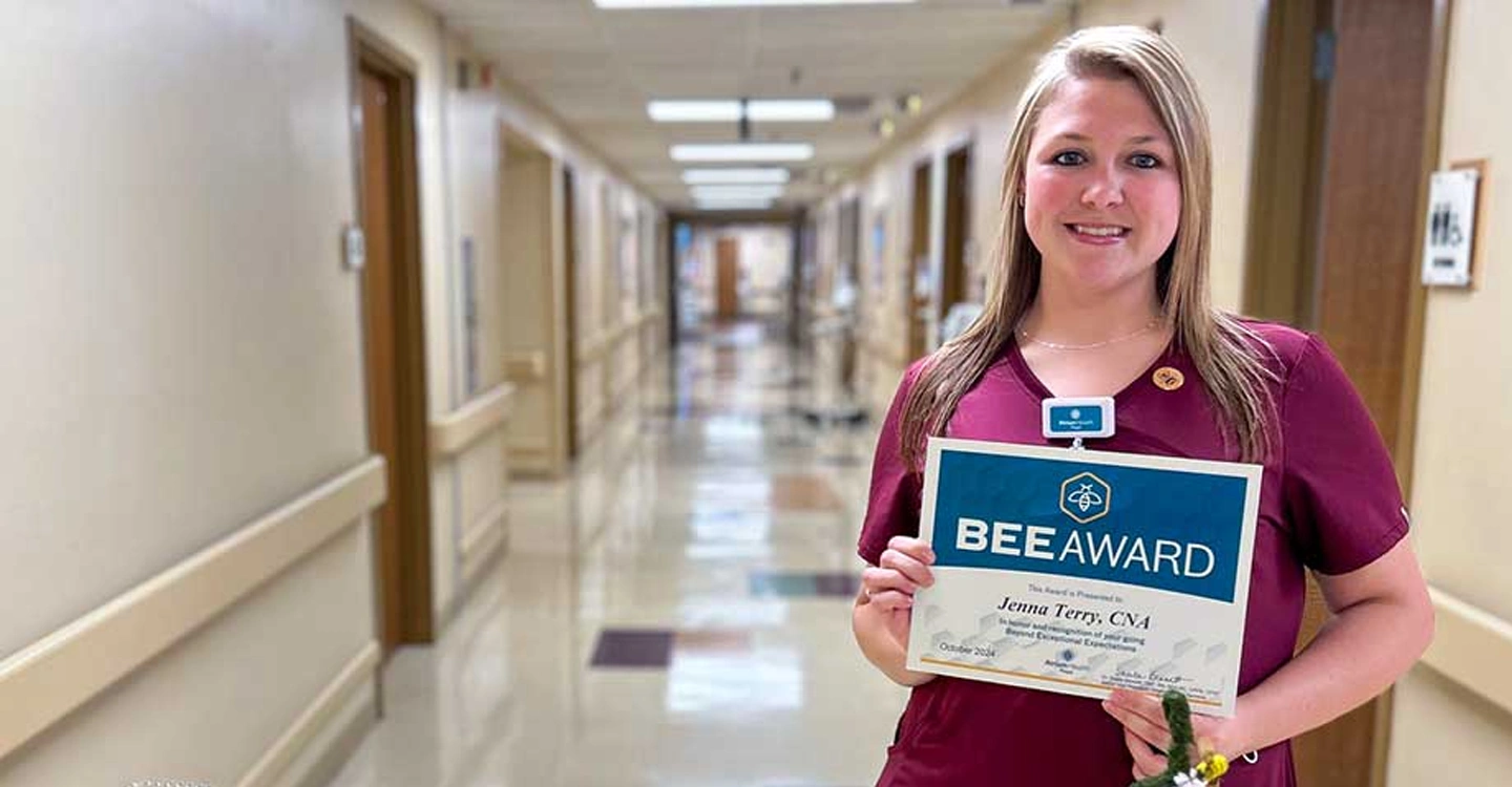 Jenna Terry holds her BEE Award certificate