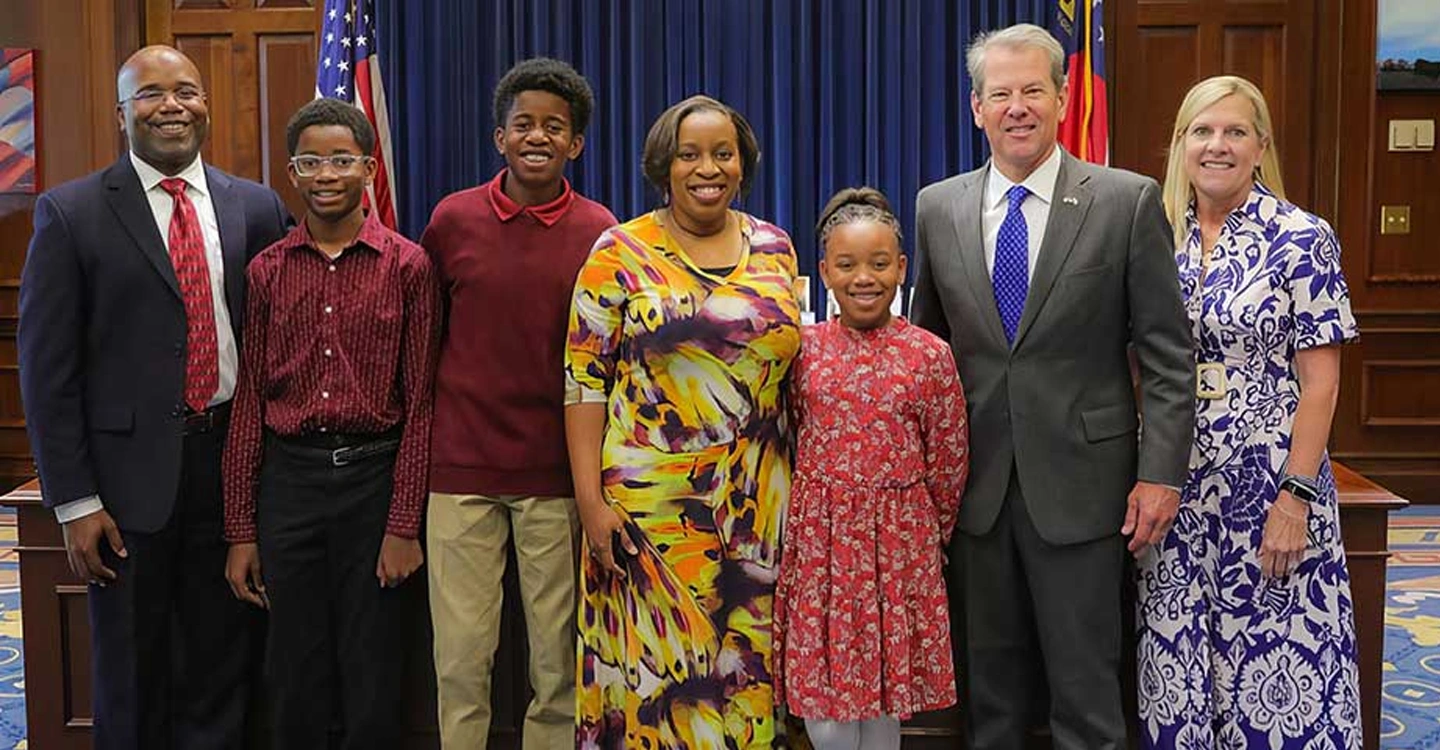 Dr. Sylvia Washington with her husband and three children, as well as Governor Brian Kemp and his wife